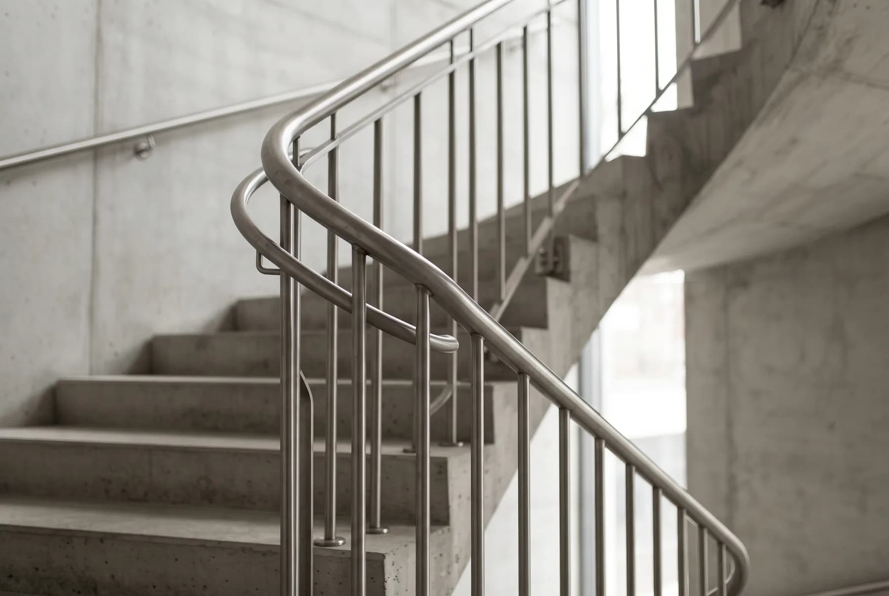Stainless architectural handrail with continuous smooth curves.